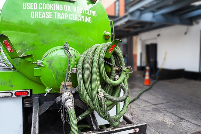 large truck pumping grease trap at a restaurant in Apple Valley